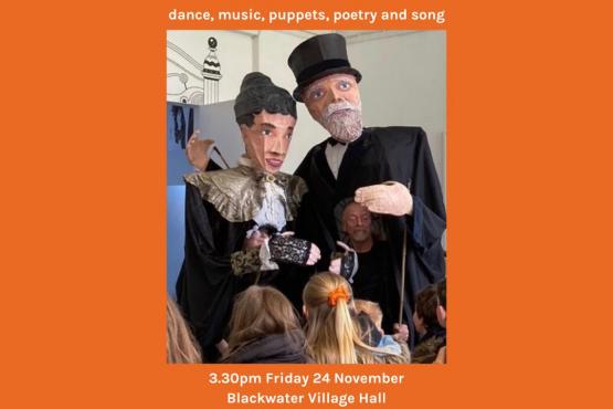orange poster with 2 giant puppets and information