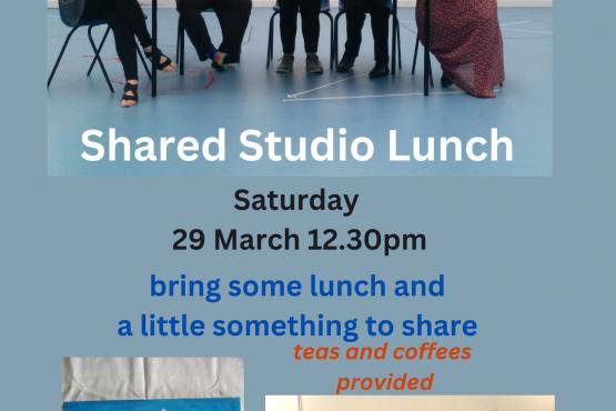 4 people at a table Shallal Studio lunch, painting of a cat with bird on head and photo of a group of smiling people