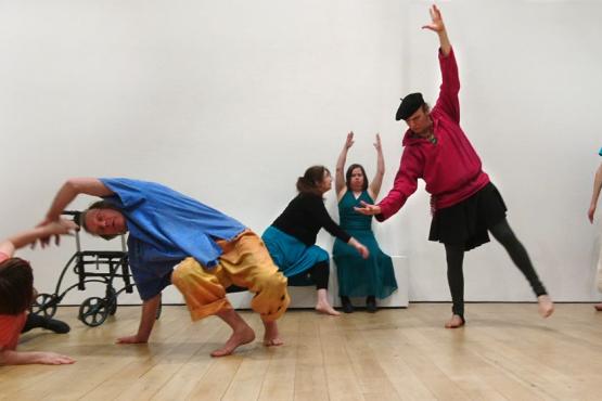 a group of 6 people dancing in a hall like space