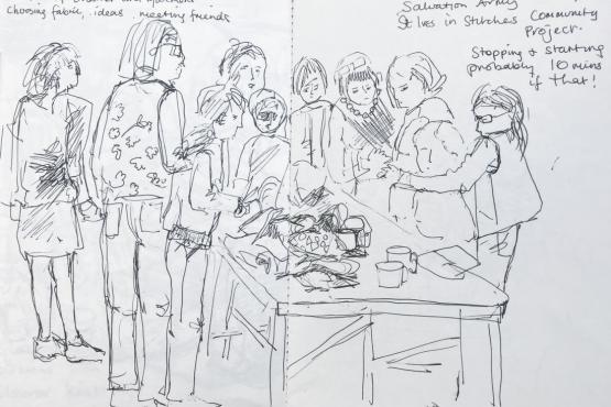A black and white drawing of people standing around a table with mugs and sketchbooks