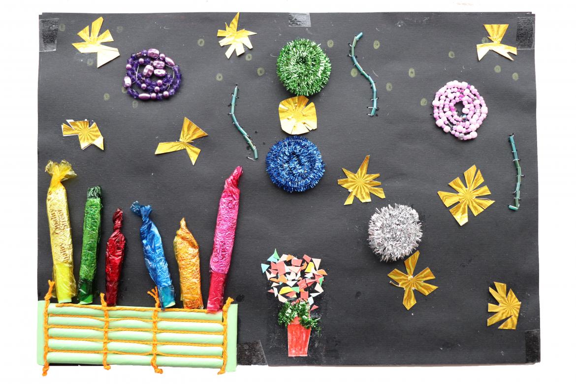 Tinsel rolled into balls and gold paper stars on black paper representing fireworks