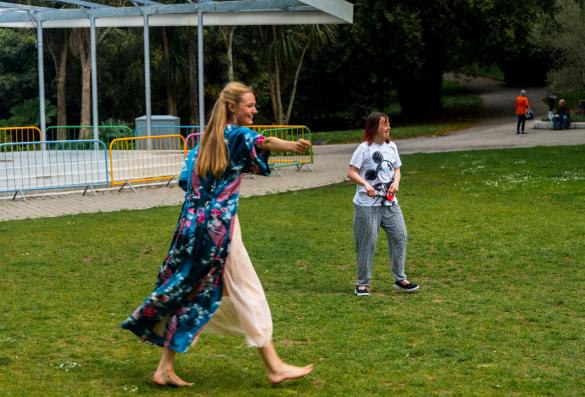 2 people dancing in a park