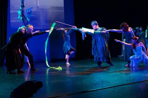 A group performing on a dark stage