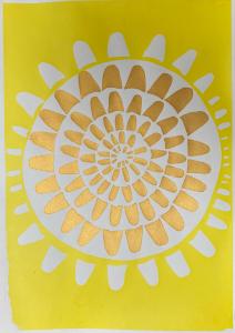 A bright and joyful screen-printed circular pattern in gold on a yellow background