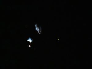 a persons head being lit up in dark night sky