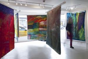 colourful abstract paintings hanging in gallery 