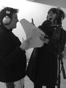 2 people singing into a microphone 