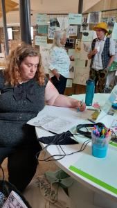 a person sitting at a table at an exhibition