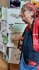a person looking at a drawing hung on the wall