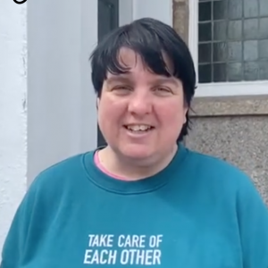 woman with dark short hair and blue shirt with take care of each other