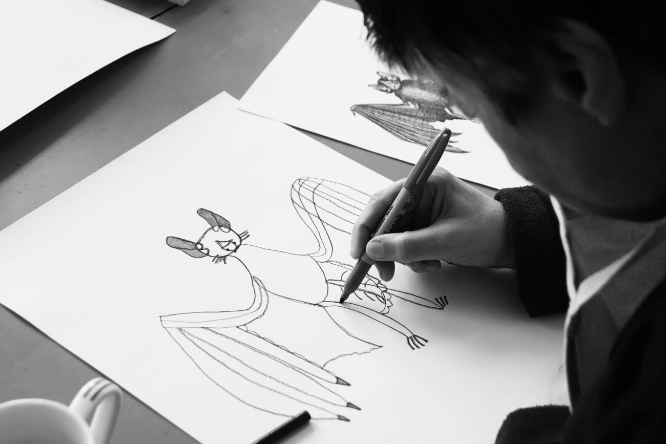 a person drawing a bat