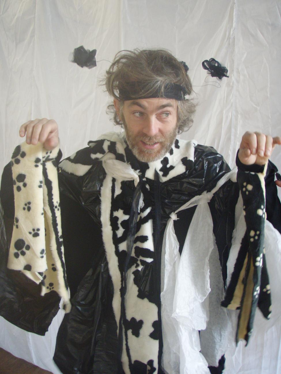 a person dressed up in a black and white costume with black antennae 