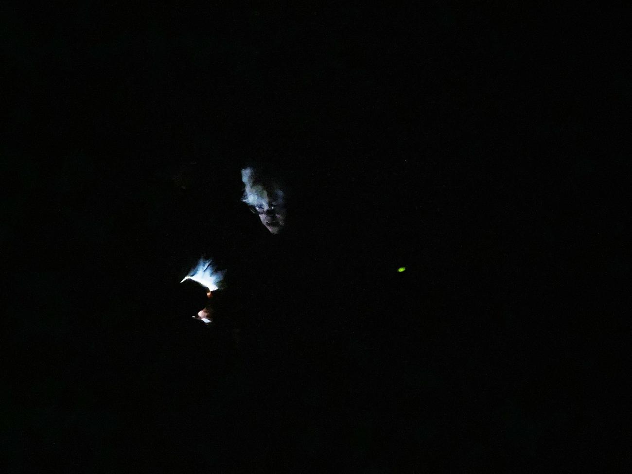 a persons head being lit up in dark night sky
