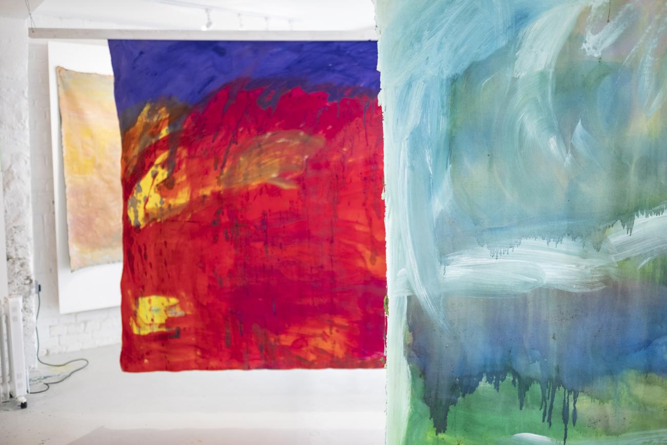 colourful abstract paintings hanging in gallery 