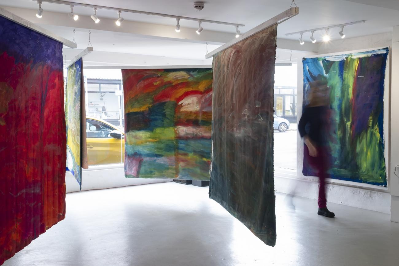 colourful abstract paintings hanging in gallery 