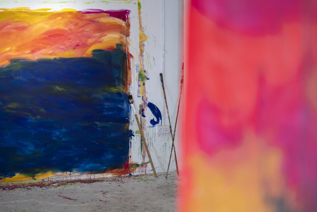 colourful abstract paintings hanging in gallery 