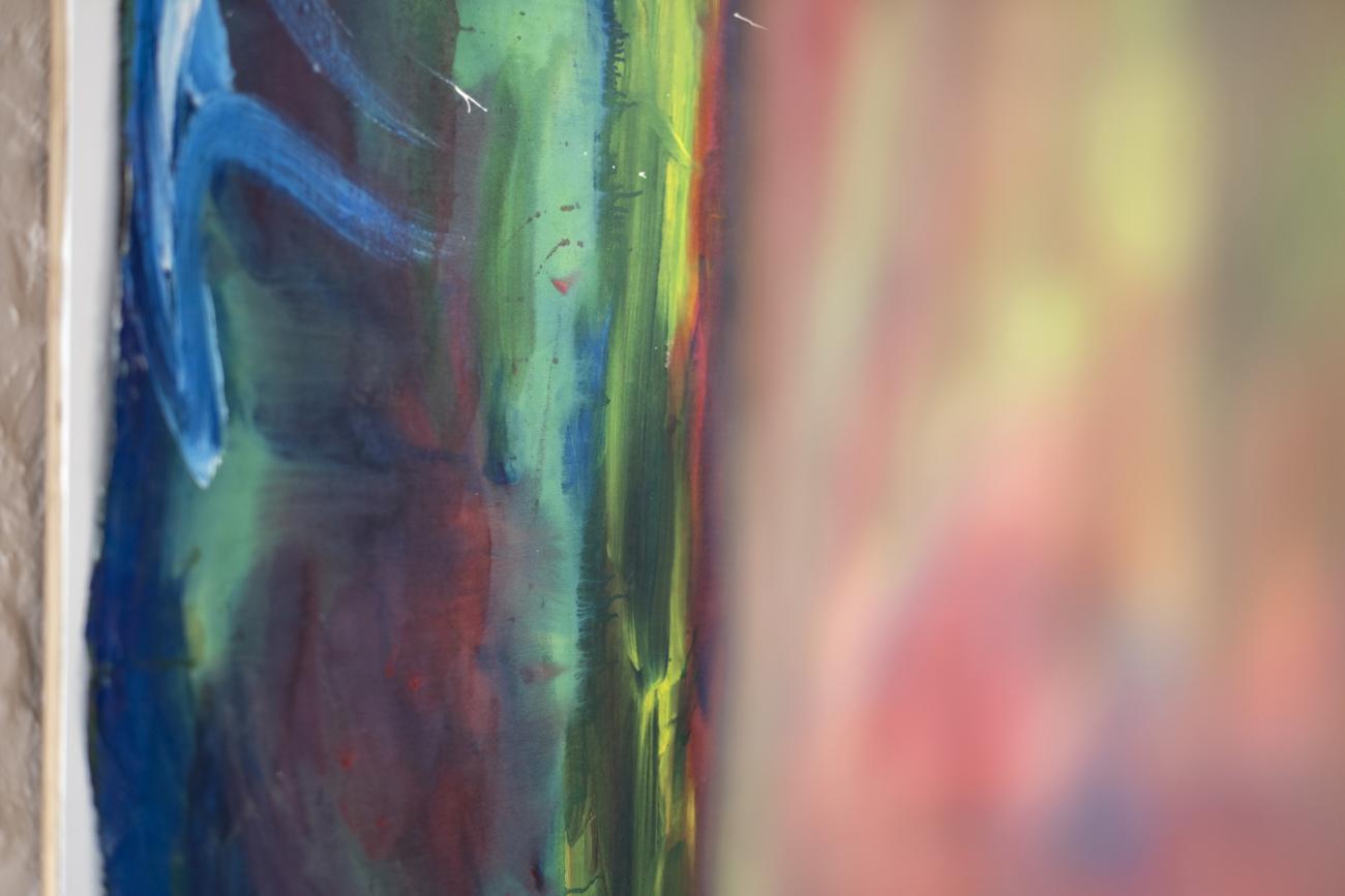 colourful abstract paintings hanging in gallery 