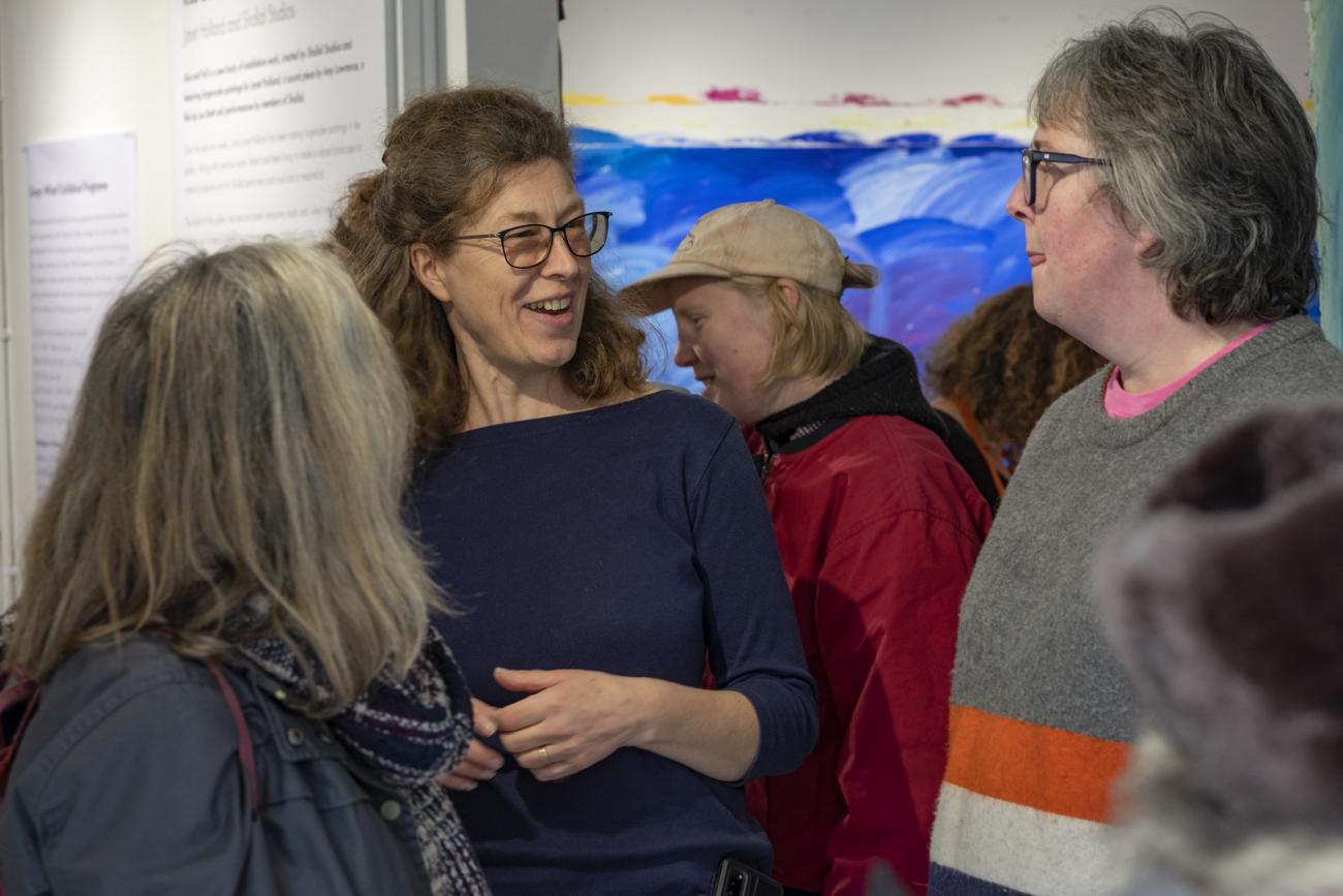 people talking at Rise and Fall exhibition 