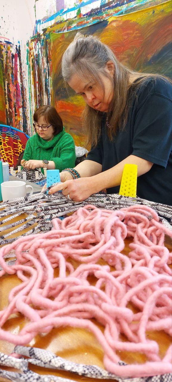 2 people french knitting with colourful wool in Shallal Studios